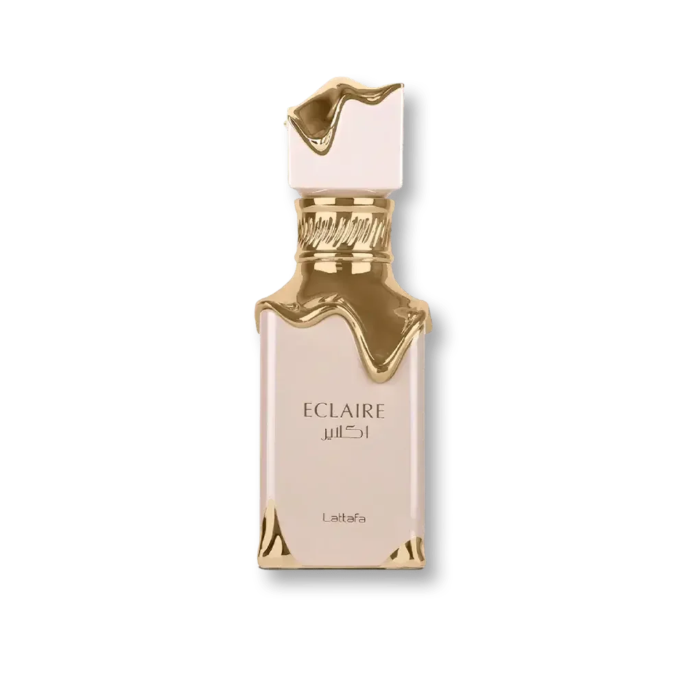 Luxuriöses Parfum Eclaire Flakon in Gold und Creme mit elegantem Design vor grünem Hintergrund